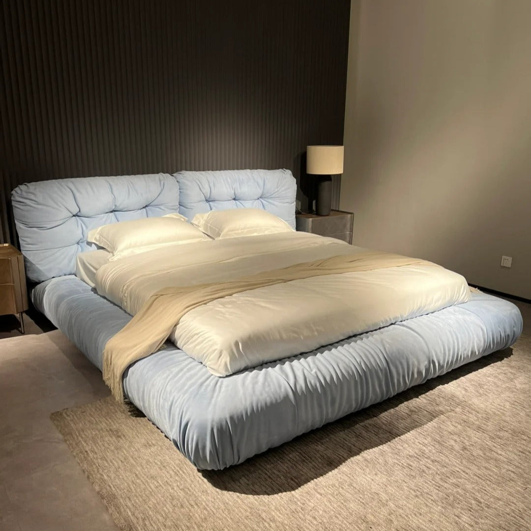 A luxurious beige upholstered Italian-style Cloud Bed with a high headboard and plush cushioning, resembling the softness of clouds.