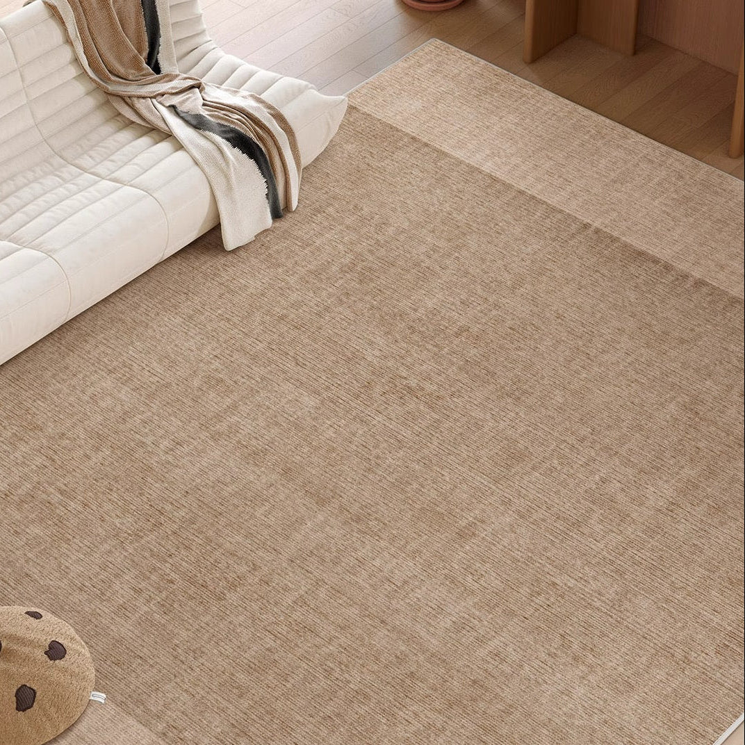 Close-up view of the Alpine Luxe Rug in warm beige, showing its soft texture beside a white sofa and wooden flooring.