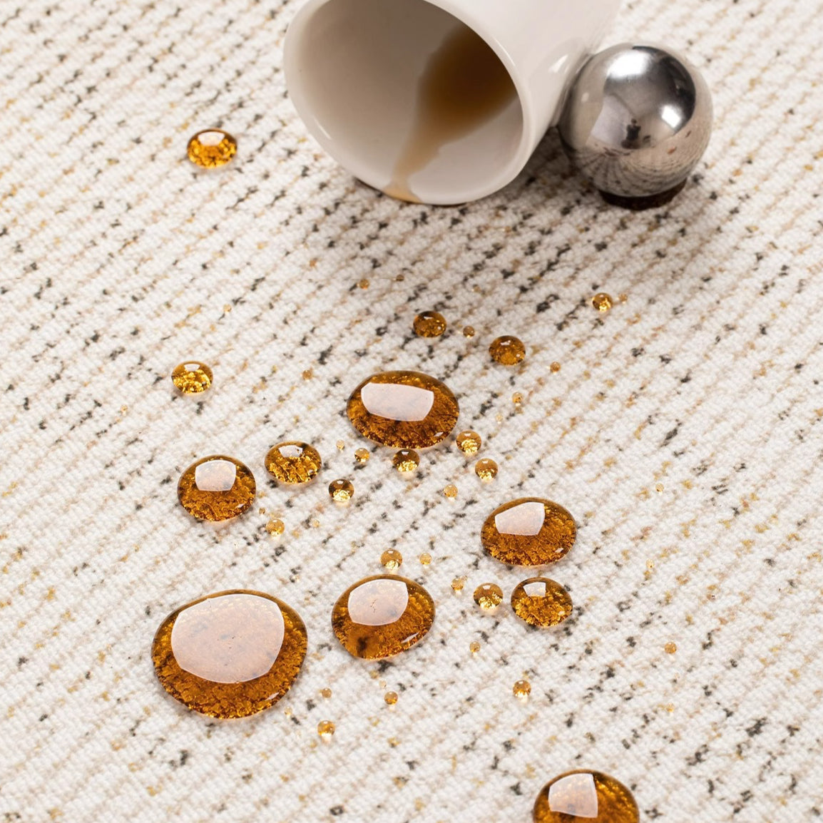 Close-up of the Alpine Luxe Rug showing water-repellent performance with spilled droplets beading on the surface