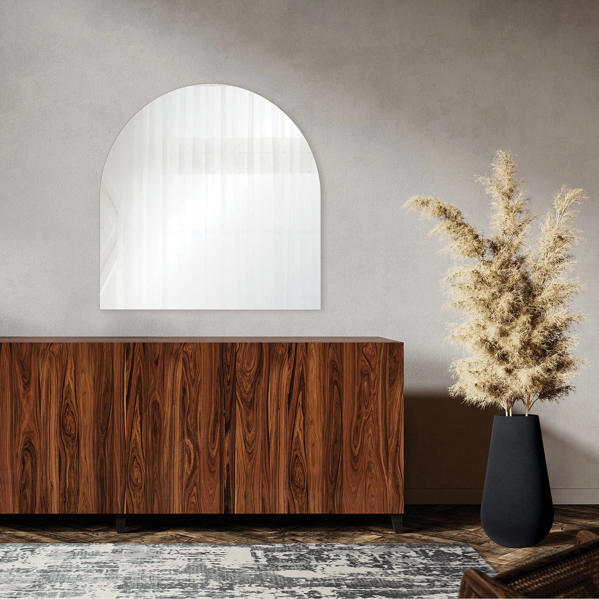 Arco Wall Mirror displayed above a wooden sideboard in a modern living room with a tall black vase and neutral decor