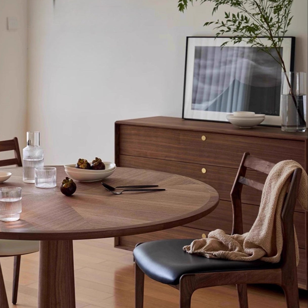 Aspen Classic Dining Chair with walnut frame and black seat cushion styled beside a round wood dining table