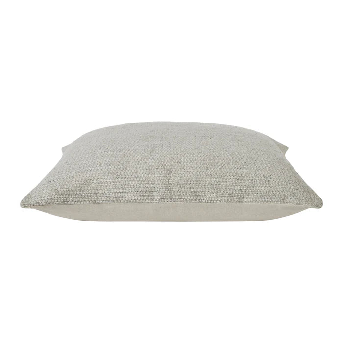 Side profile view of the plush beige Bennett throw pillow showcasing its thickness and tailored seam detailing.