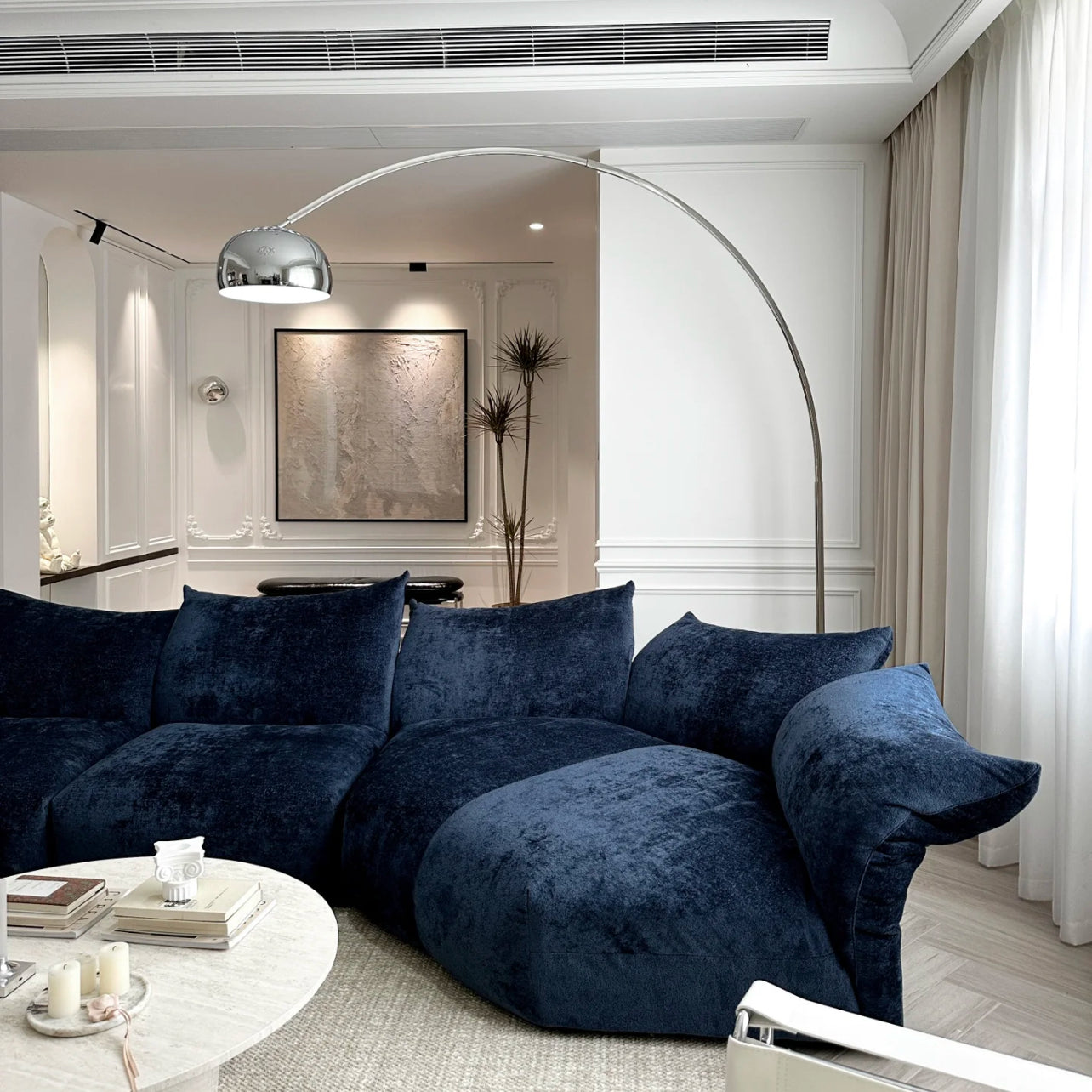 Close-up of Blooming Embrace Modular Sofa in navy blue fabric featuring deep seating and soft cushions in a modern living room setup