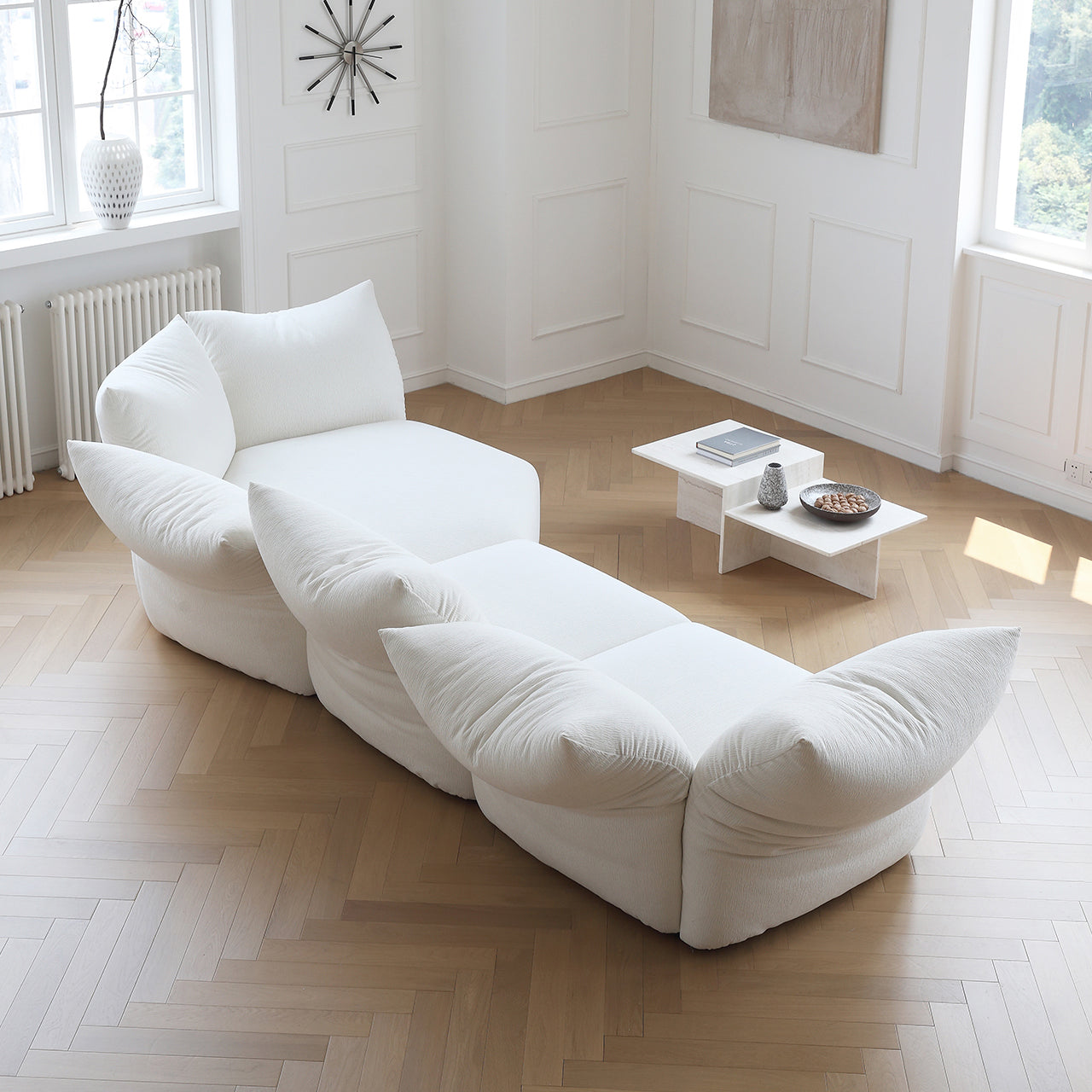Top view of Blooming Embrace Modular Sofa in white fabric arranged in a curved layout within a bright modern living room