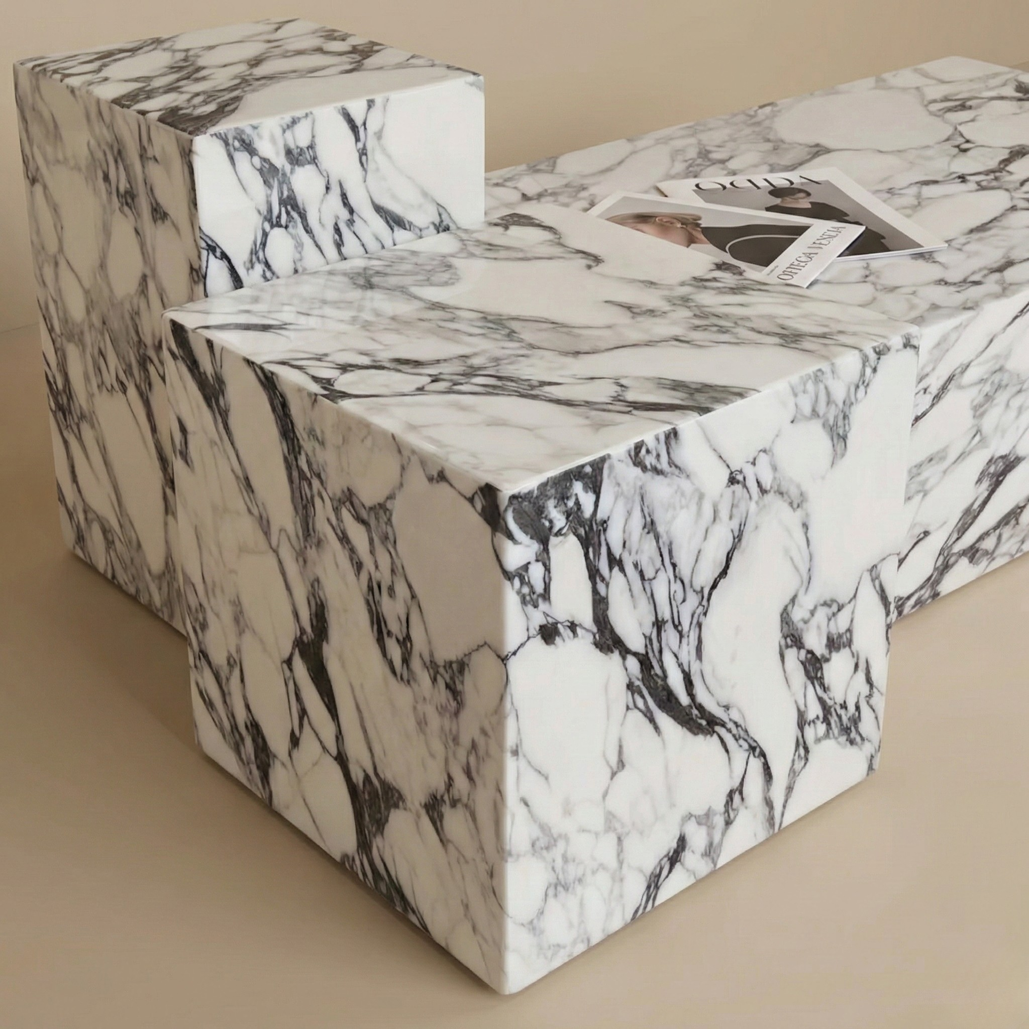 Close up detail of the Bulgari Charm marble tables showing the dramatic purple and white stone veining and sharp geometric edges.