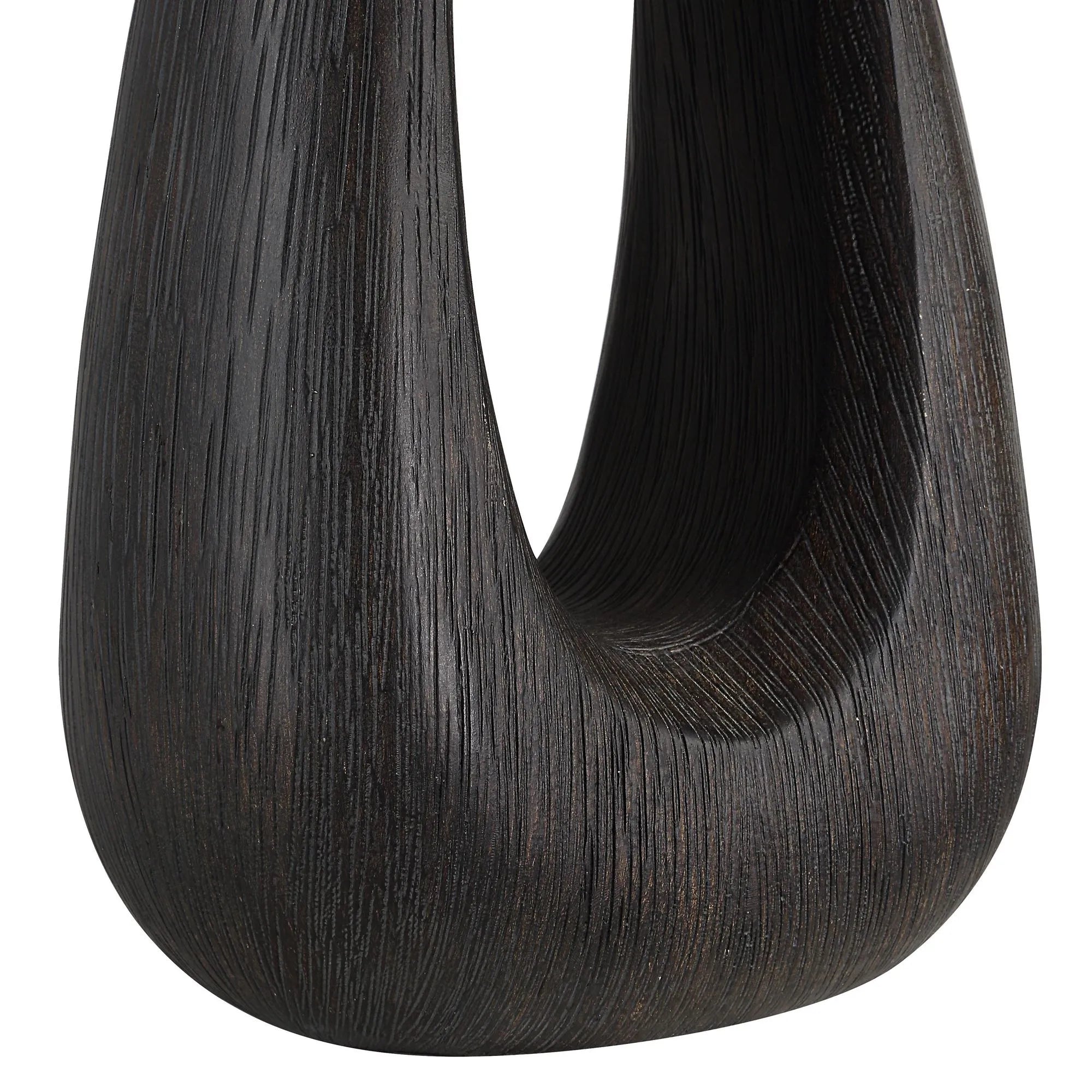 Close-up of Calla Table Lamp showcasing the textured black wood base with smooth sculptural finish