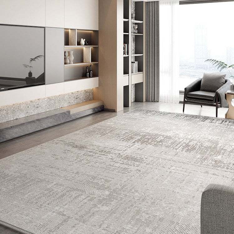 Calm Grey Haven Rug in a modern bright living room with built-in shelving and lounge chair