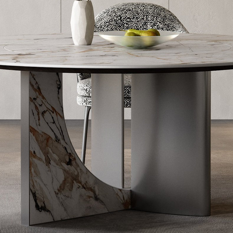 Close-up of Celesti Elegance round dining table showcasing marble-patterned top and stainless steel cross base with artistic detailing