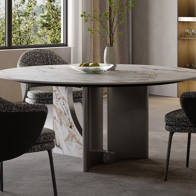 Celesti Elegance round dining table with marble-patterned sintered stone top and stainless steel base, styled with modern chairs beside a large window