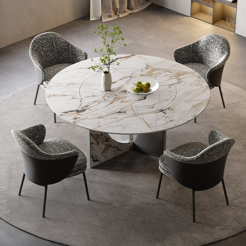 Celesti Elegance round dining table with marble-patterned top and stainless steel base styled with four upholstered chairs in a modern dining room