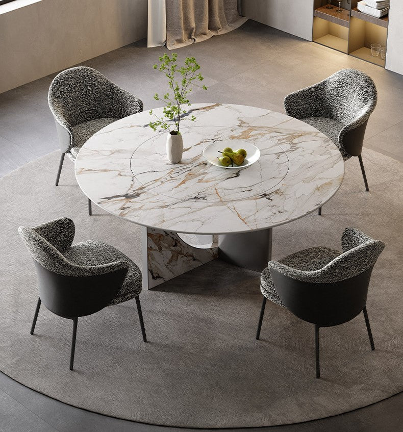 Celesti Elegance round dining table with marble-patterned top and stainless steel base styled with four upholstered chairs in a modern dining room