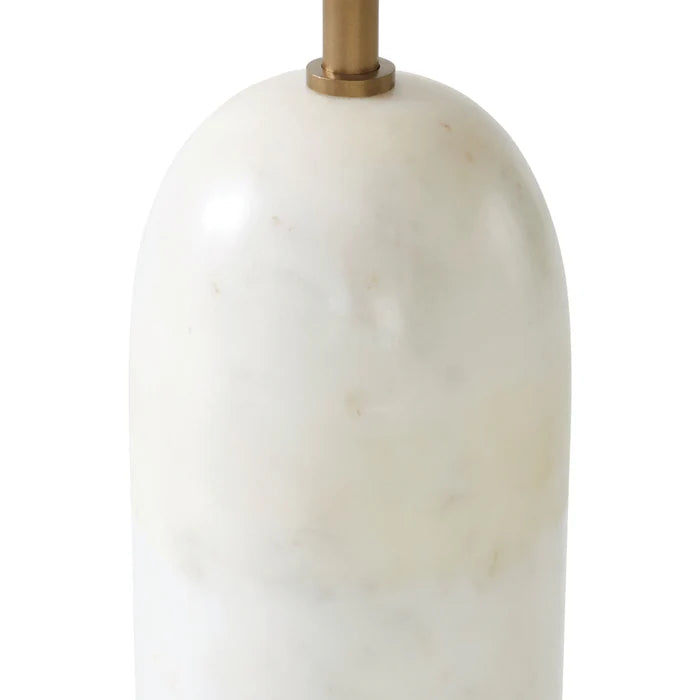 Close up of the Celine floor lamp's solid white marble cylindrical base with natural grey veining and brass neck detail.