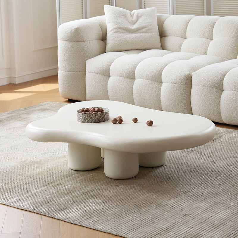 Cloud Shape Coffee Table with sculptural white base styled in cozy living room with cream boucle sofa and neutral rug