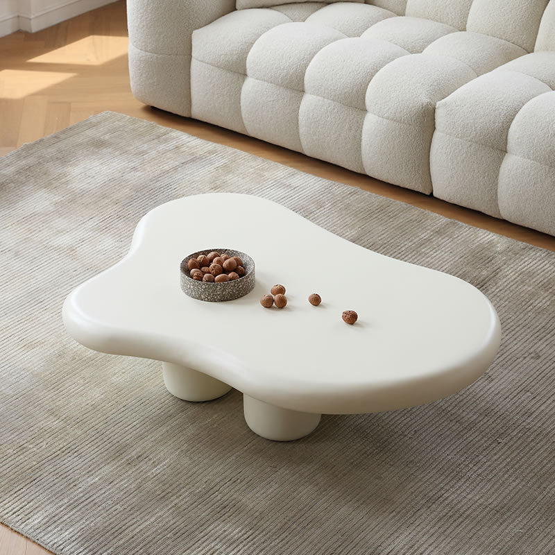 "Cloud Shape Coffee Table in matte white finish styled with neutral sofa and rug in a cozy minimalist living room