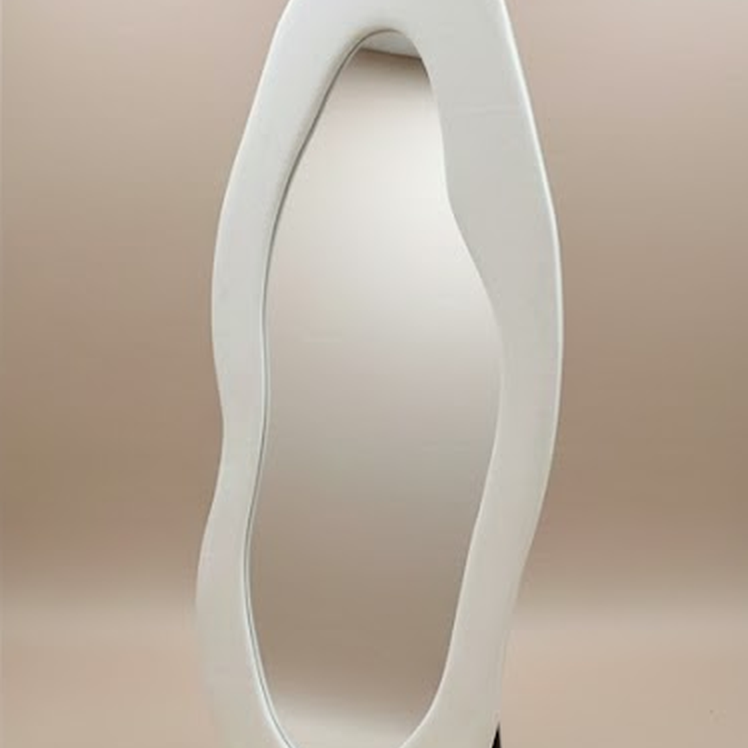 Cloud-shape full body mirror with an irregular white wavy frame, angled view on beige background.