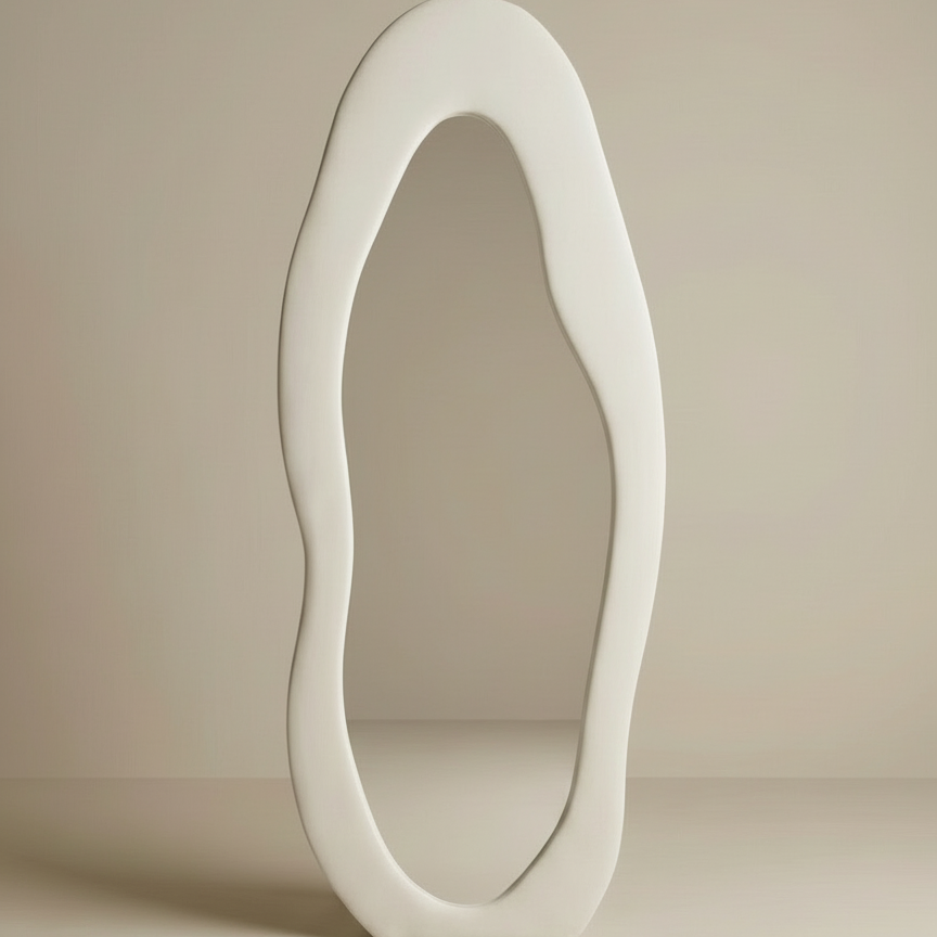 Cloud-shape full body mirror with an organic wavy white frame on a beige studio background.