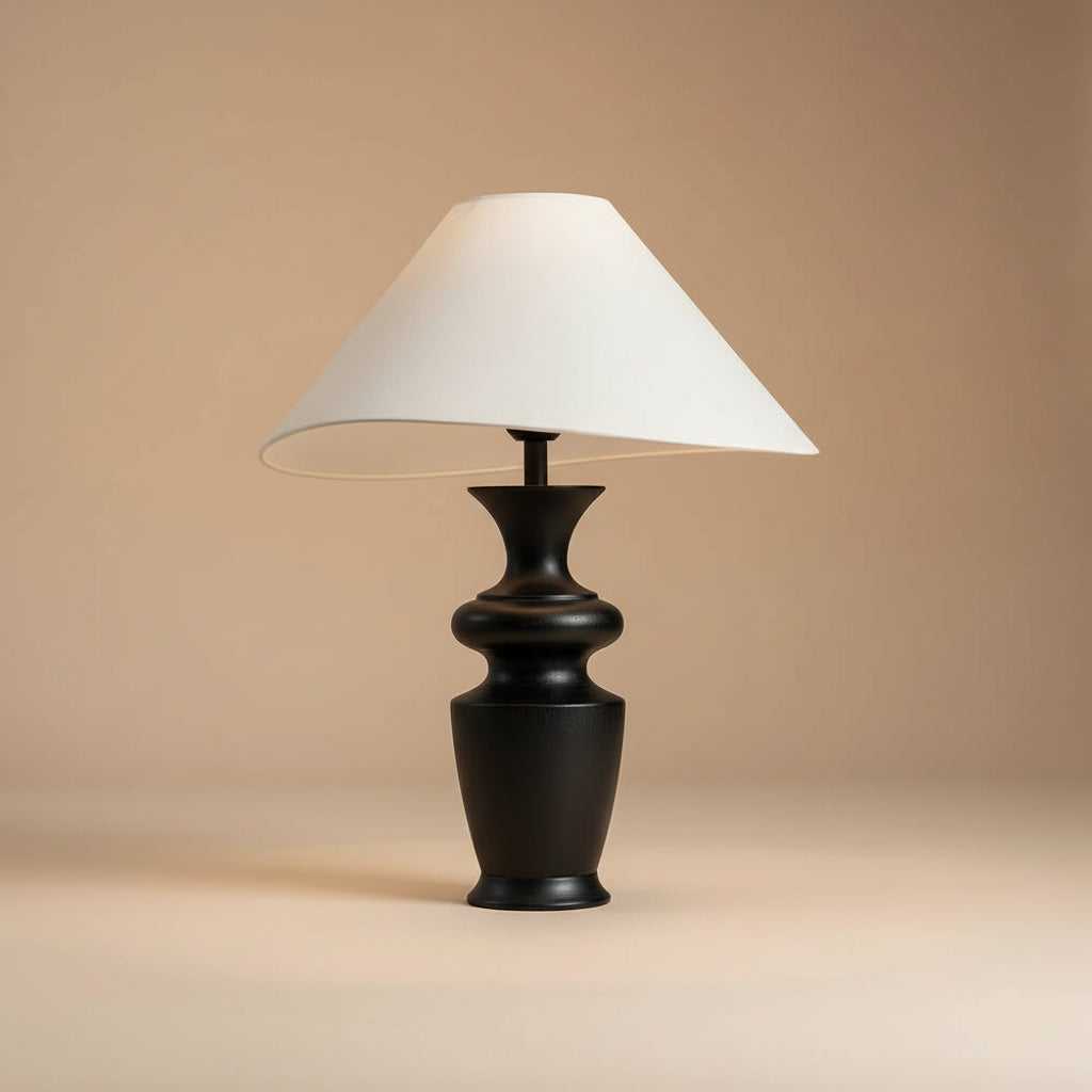 Contour Table Lamp with black sculpted base and asymmetrical white shade in a beige studio setting