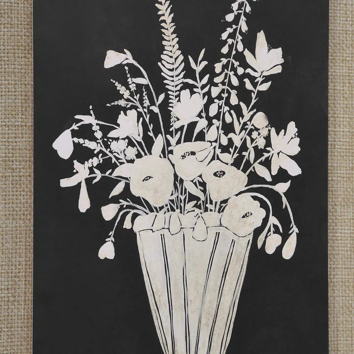 Close-up of the Daphne wall art showing a painted white botanical floral arrangement against a solid black background.