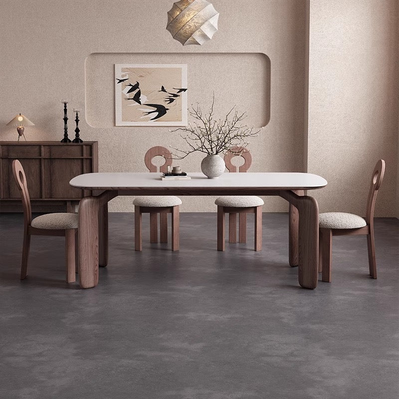 Eclipse Elegance dining table with sintered stone top and walnut curved legs styled with boucle dining chairs in a neutral modern dining room