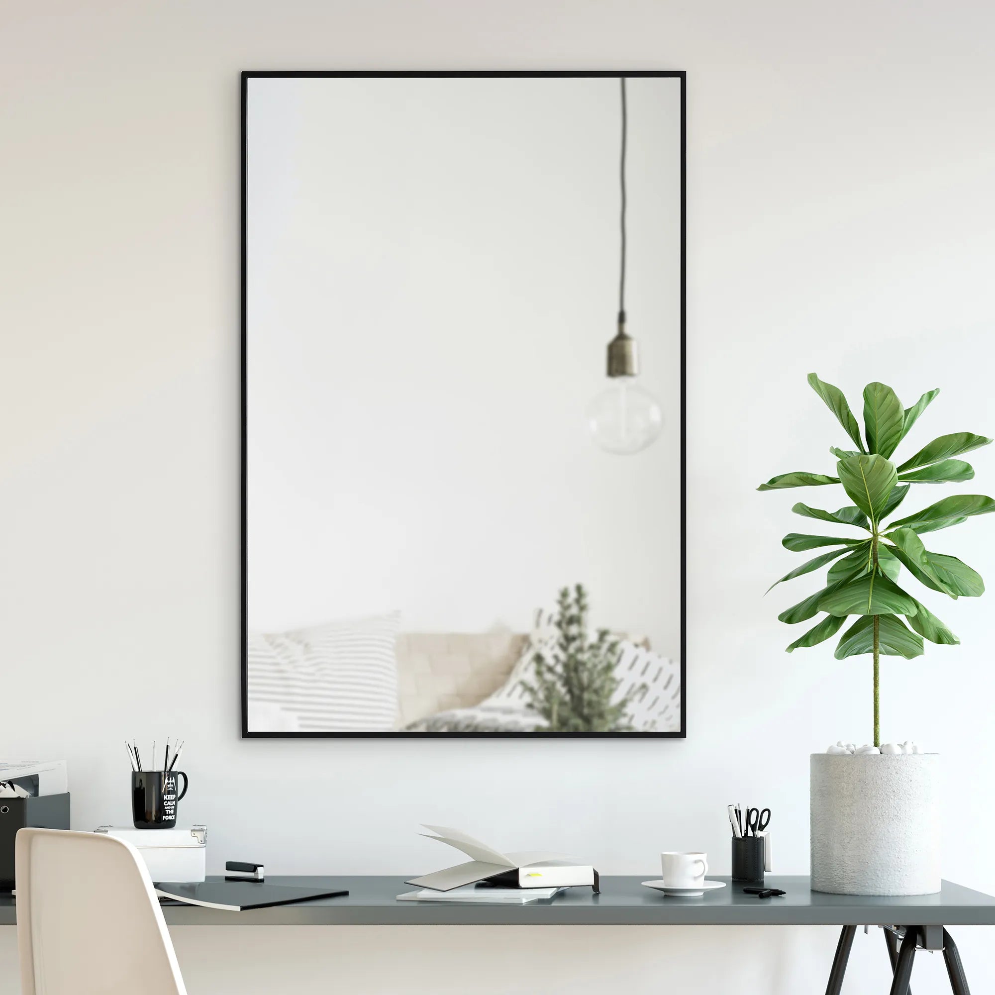 EdgeLine Wall Mirror hanging above a modern desk with plant and decor in a bright room