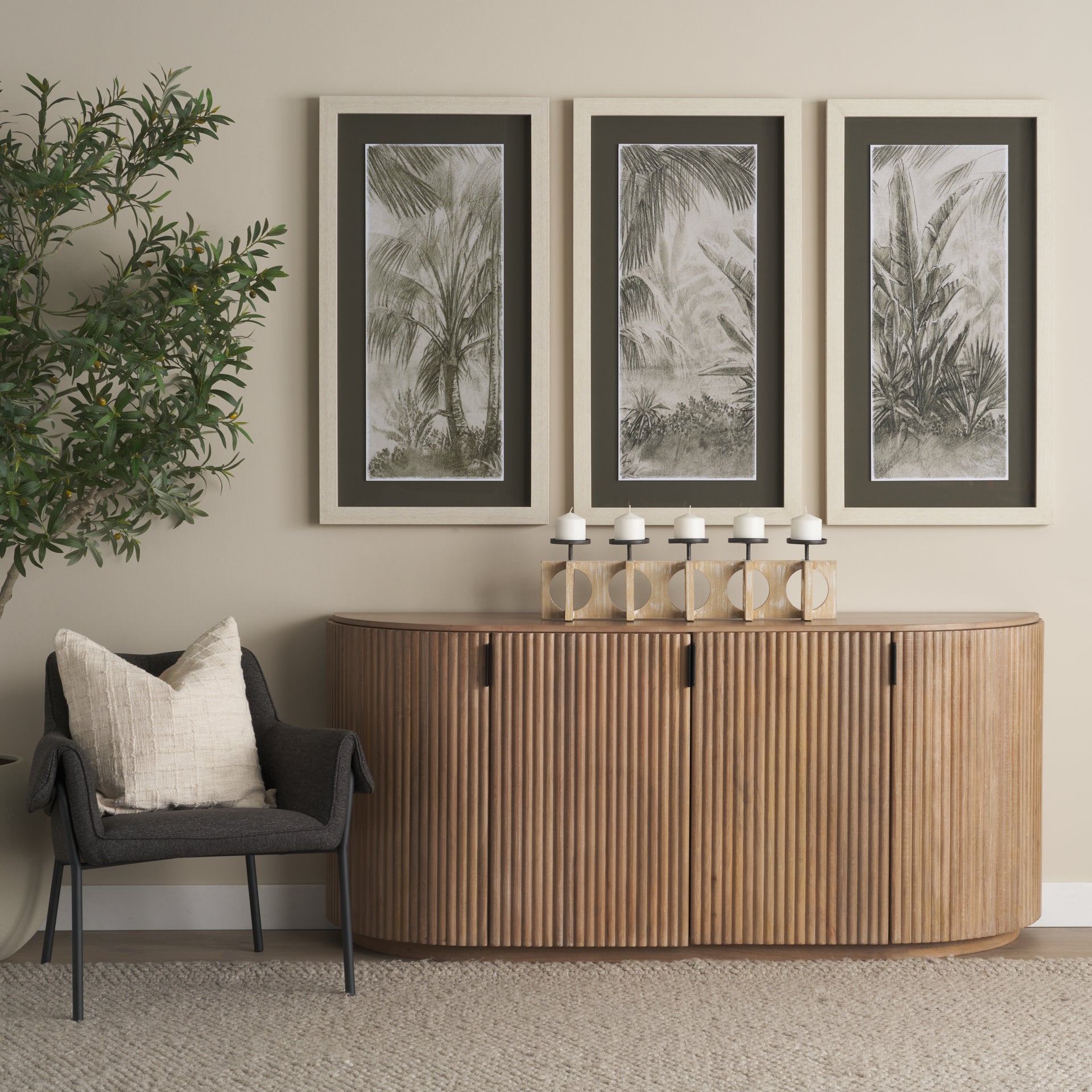 The Eleanor light mango wood sideboard styled with an olive tree and earthy decor in a bright living room.