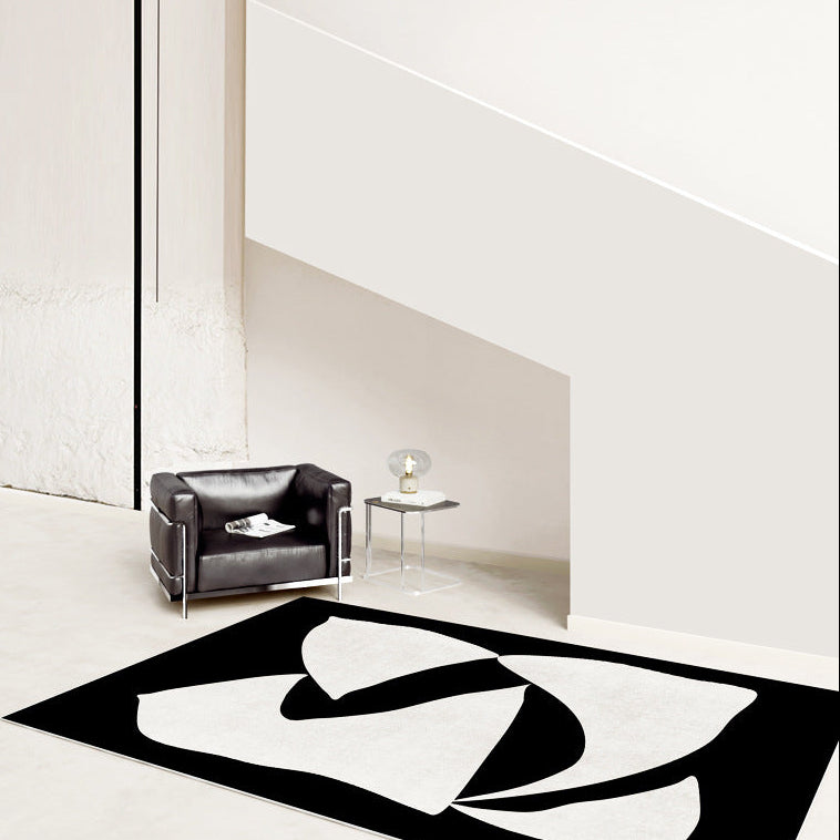 Elegance in Motion Rug in a minimalist space with black and cream abstract design