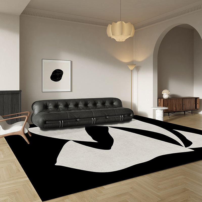 Elegance in Motion Rug styled in a modern living room with bold black and cream abstract shapes