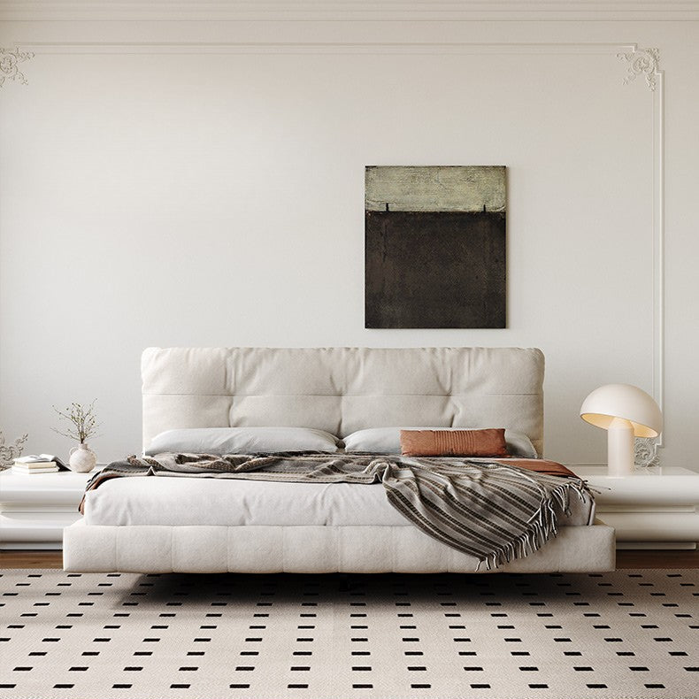 Floating Platform Bed Frame in beige fabric with tufted headboard and striped throw in minimal modern bedroom