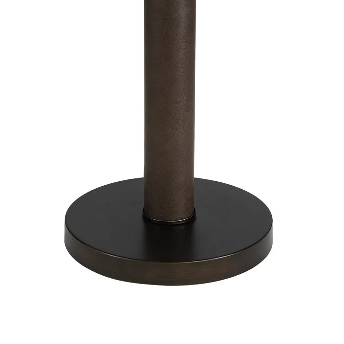 Close-up of the round dark bronze base and textured pole of the Harrison floor lamp.
