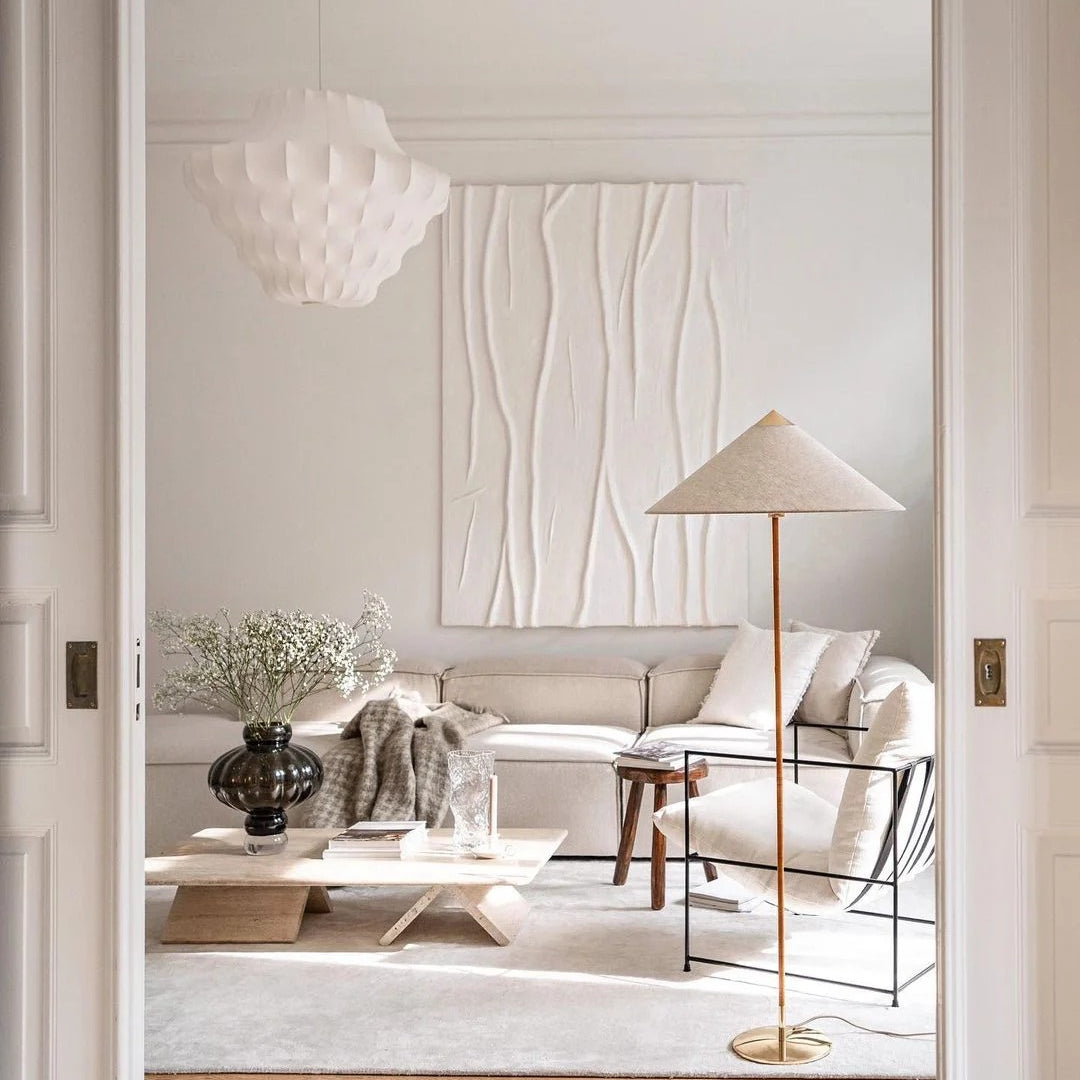 Horizon Shade Floor Lamp with brass base and linen cone shade in a minimalist neutral living room with cream sofa and wood accents