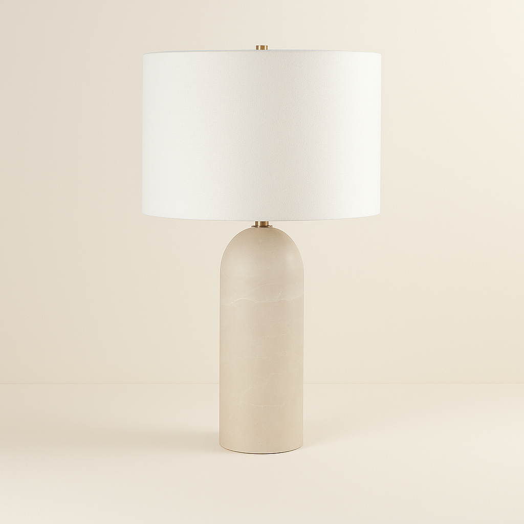 Iris Onyx Table Lamp with smooth cylindrical beige onyx base and white drum shade on neutral studio background"