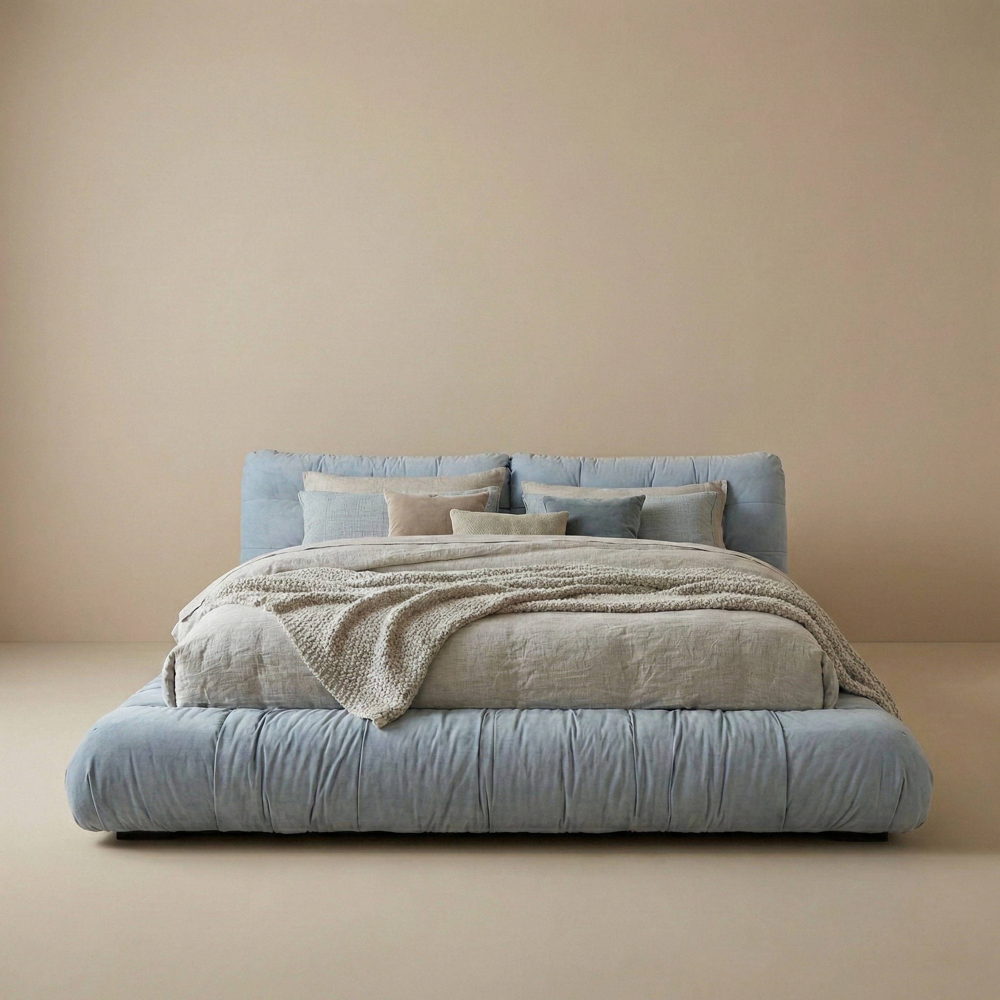 Modern Italian cloud bed frame in blue linen with a soft, unstructured silhouette and low profile design.