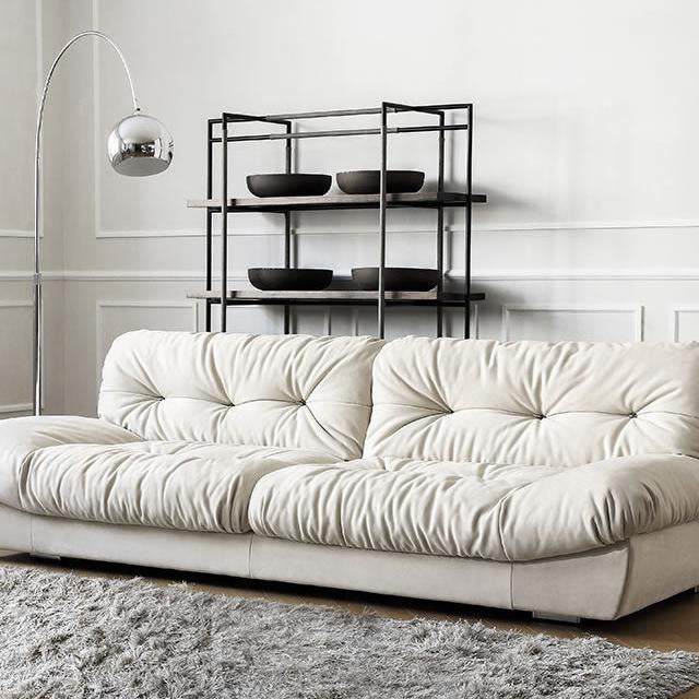 Italian-style Cloud Sofa in cream ultra suede upholstery with tufted cushions, styled in a modern living room with rug and floor lamp