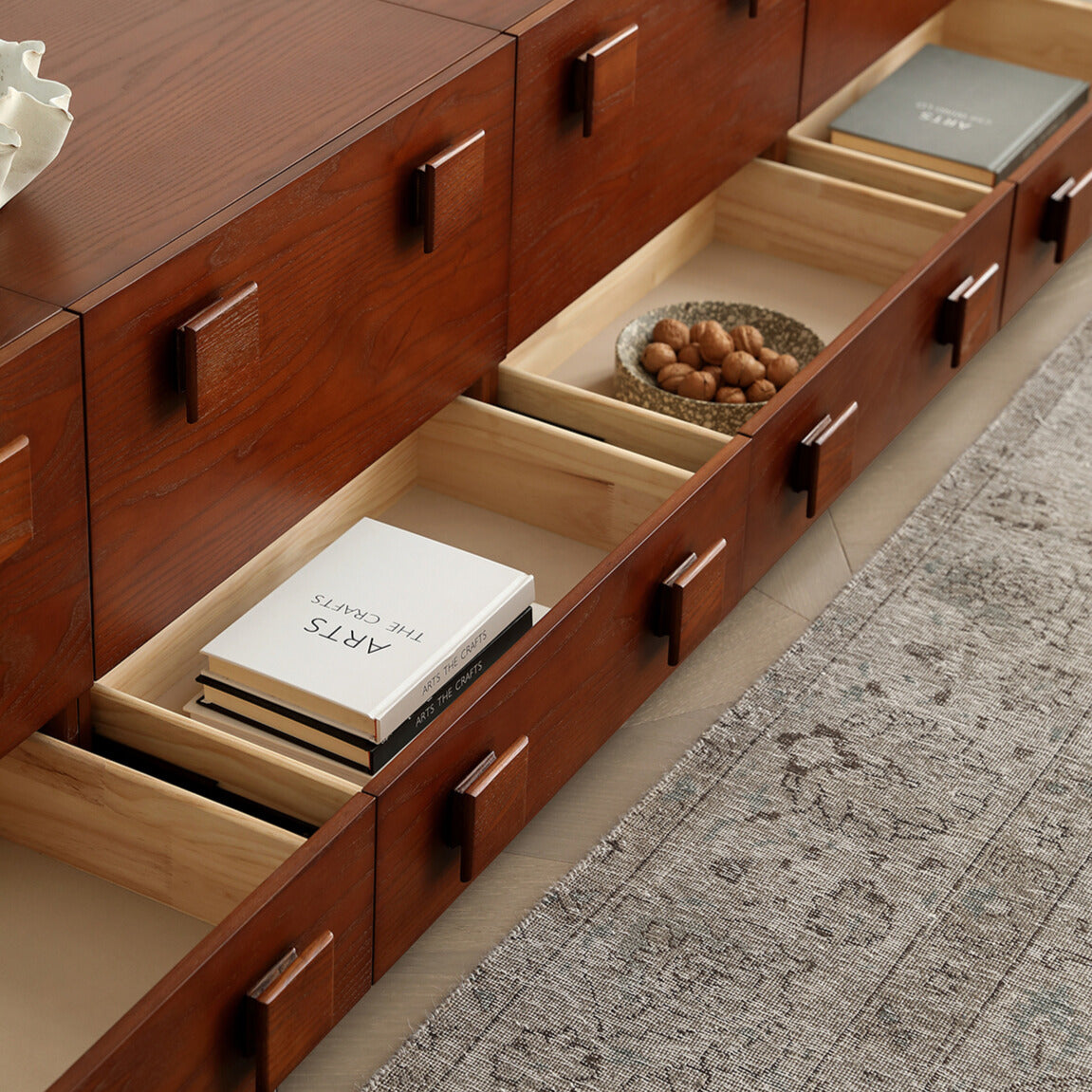 Jasper Modular Sideboard drawers open to show divided storage compartments for books, decor, and household items.