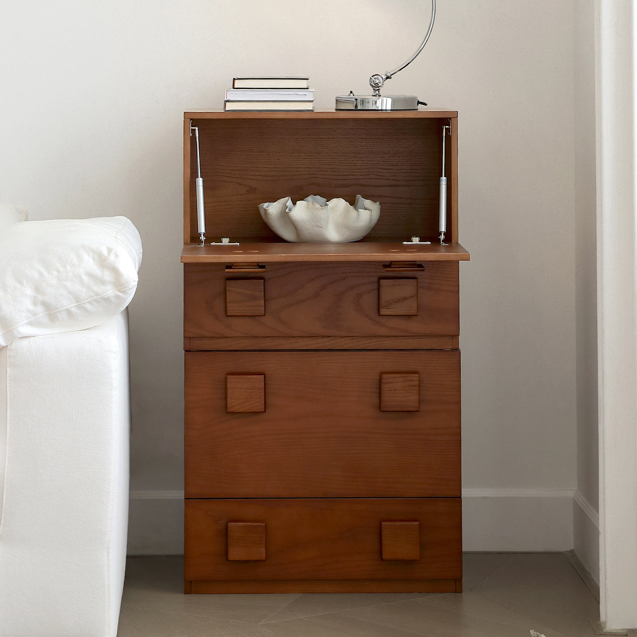 Jasper Modular Sideboard with top compartment open, showing interior storage, styled beside a sofa in a modern living room.