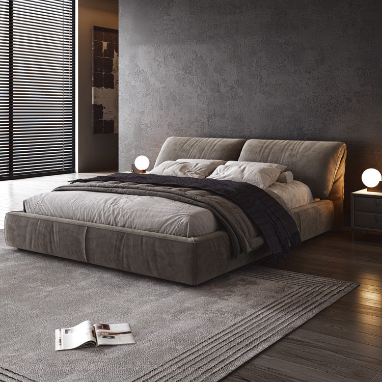 Luxury Elephant Ear Bed Frame in grey fabric with plush headboard, layered bedding, and warm lighting in modern bedroom