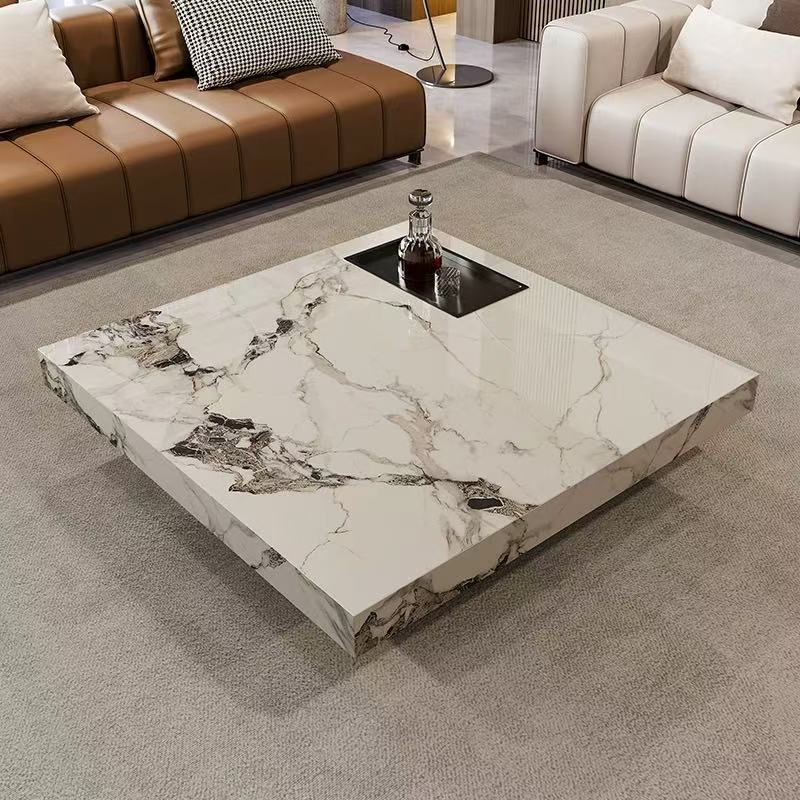 Marble Essence Coffee Table in white veined stone finish styled between brown and cream sofas in a modern living room