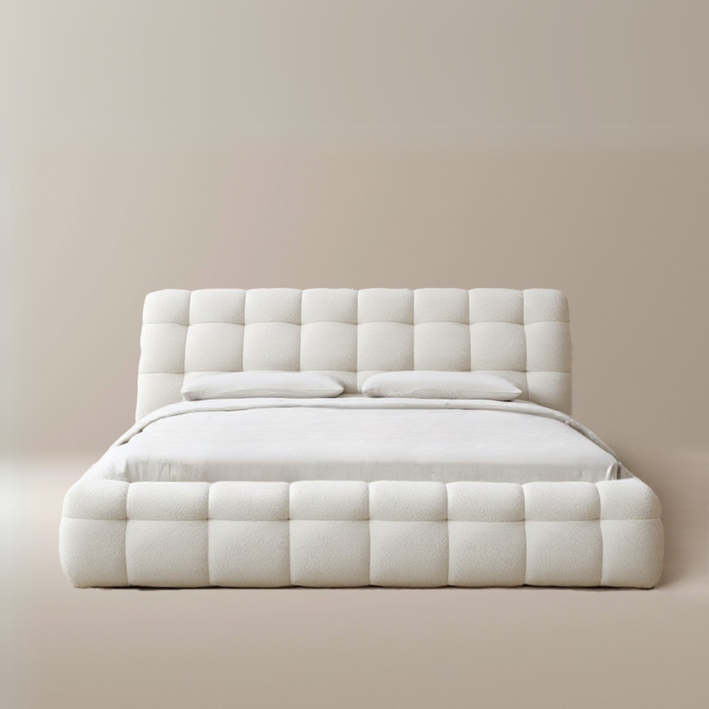Marshmallow Puff Bed with plush tufted frame and rounded padded headboard in creamy white boucle upholstery on beige background