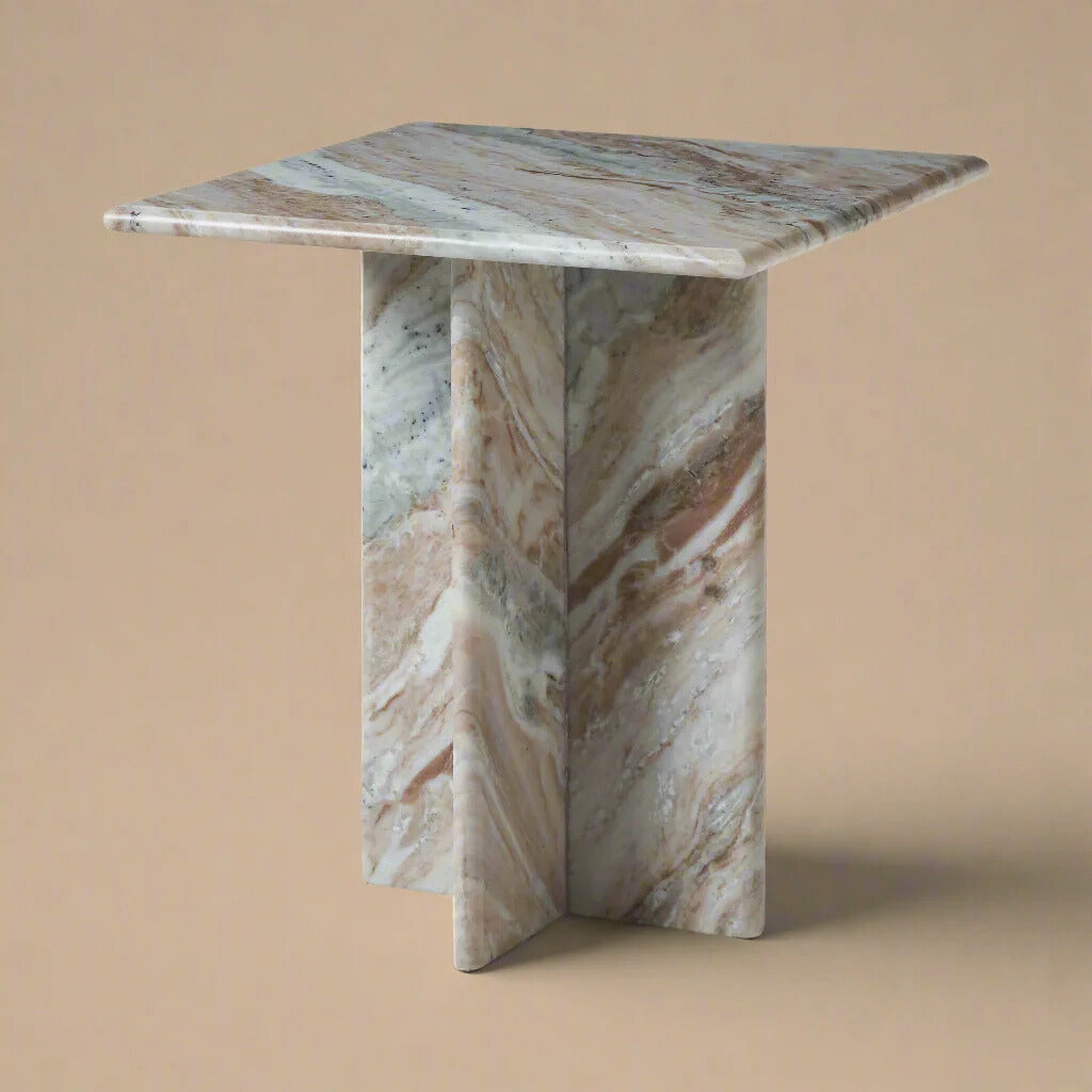 Mesa side table featuring a square top and geometric cross base in dramatic multicolor marble with pink and grey veining.