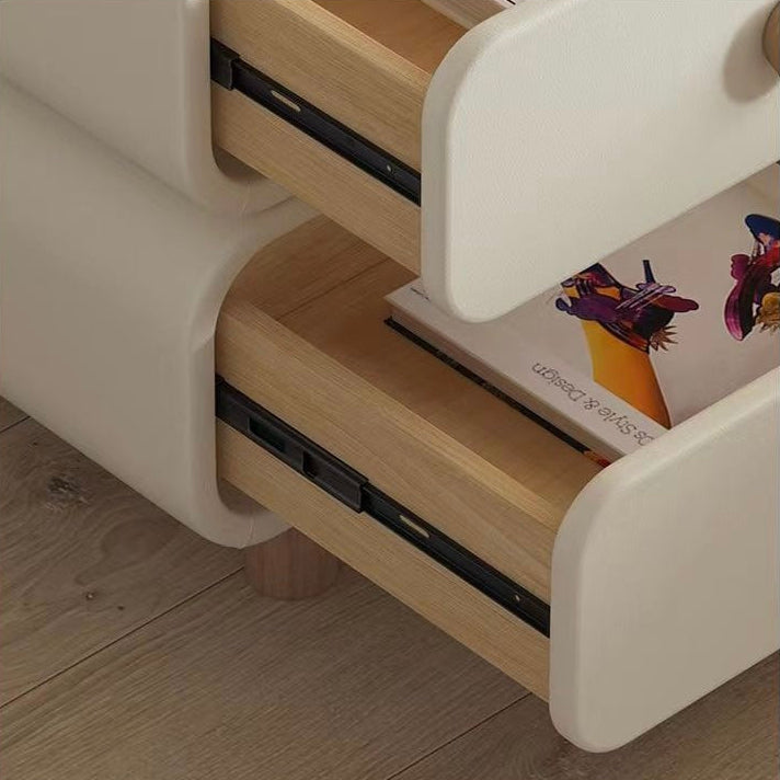 Close-up angled view of the Milan nightstand with both cream drawers pulled open, revealing the natural wood interior and smooth metal drawer glides.