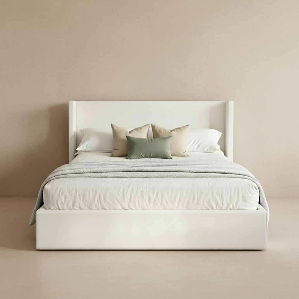 Nora Storage Bed with tall wingback headboard in soft white upholstery styled with neutral and sage accent pillows
