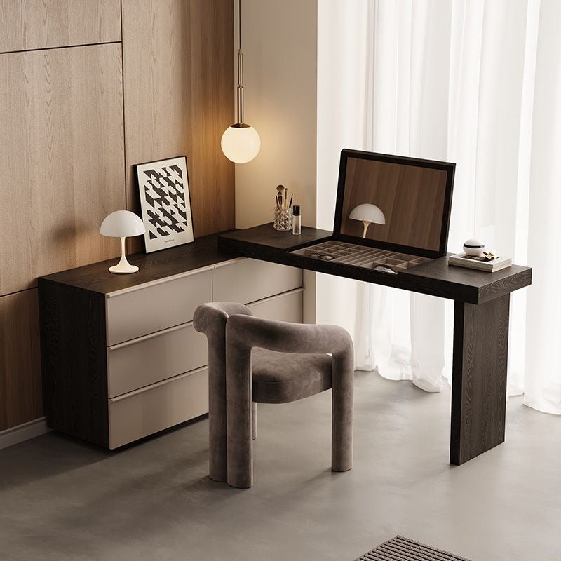 The Ovela vanity and dresser combo styled in a chic dressing room with a modern grey chair, artwork, and a standing mirror.