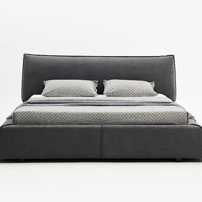 Paris Elegance Grey Platform Bed with plush upholstered headboard and patterned bedding on white studio background