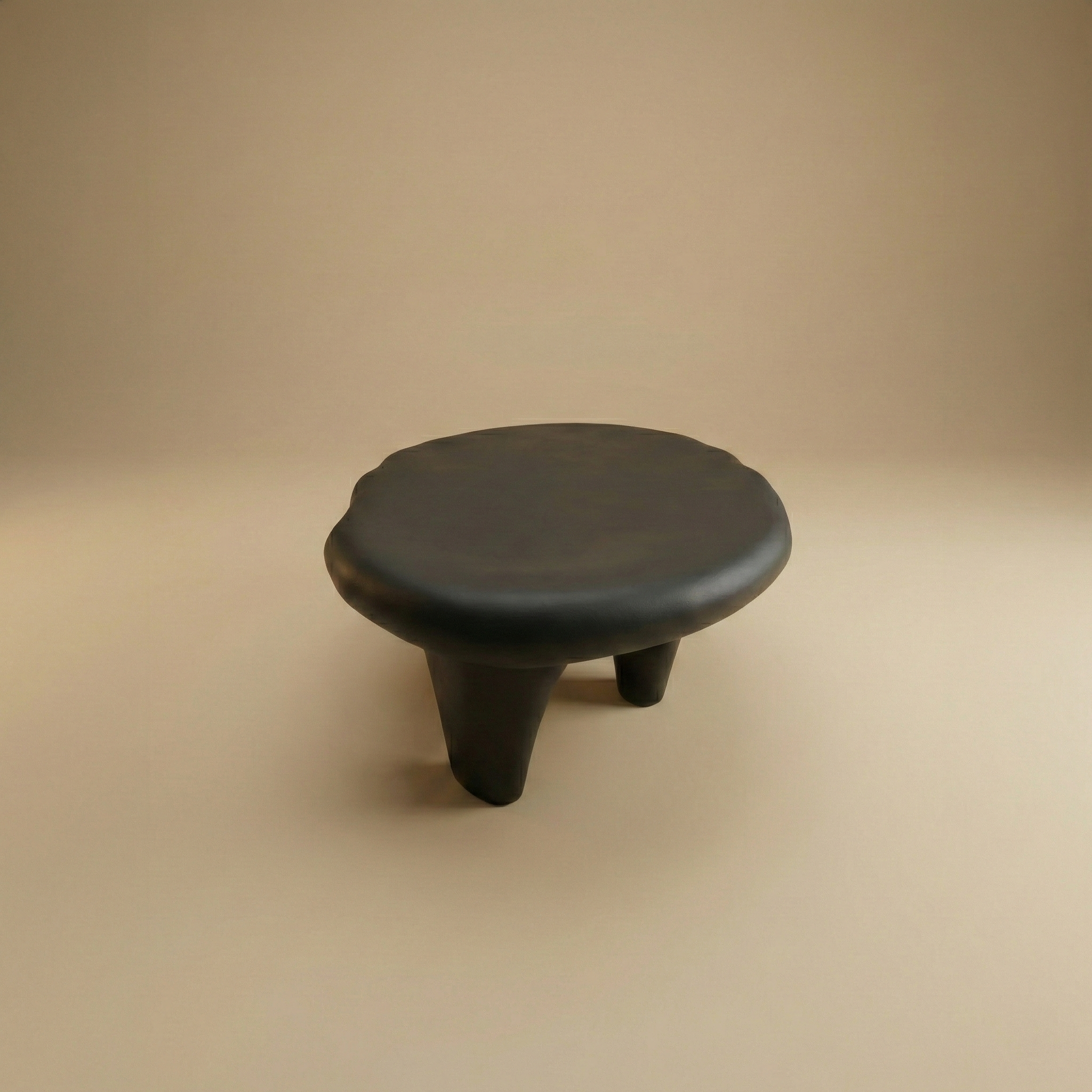 Black ceramic stool on a beige background