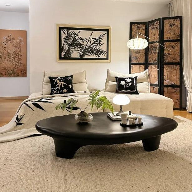 Pebble Coffee Table in matte black finish styled with beige sofa and Japanese-inspired decor in cozy living room