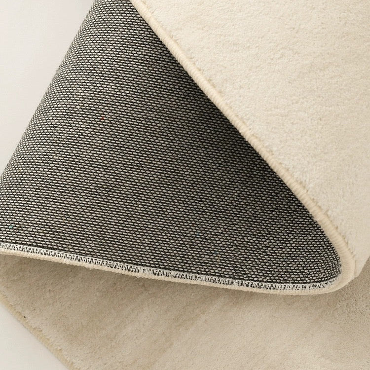 Close-up of the Sandstone Elegance Rug showing soft beige surface and durable woven backing