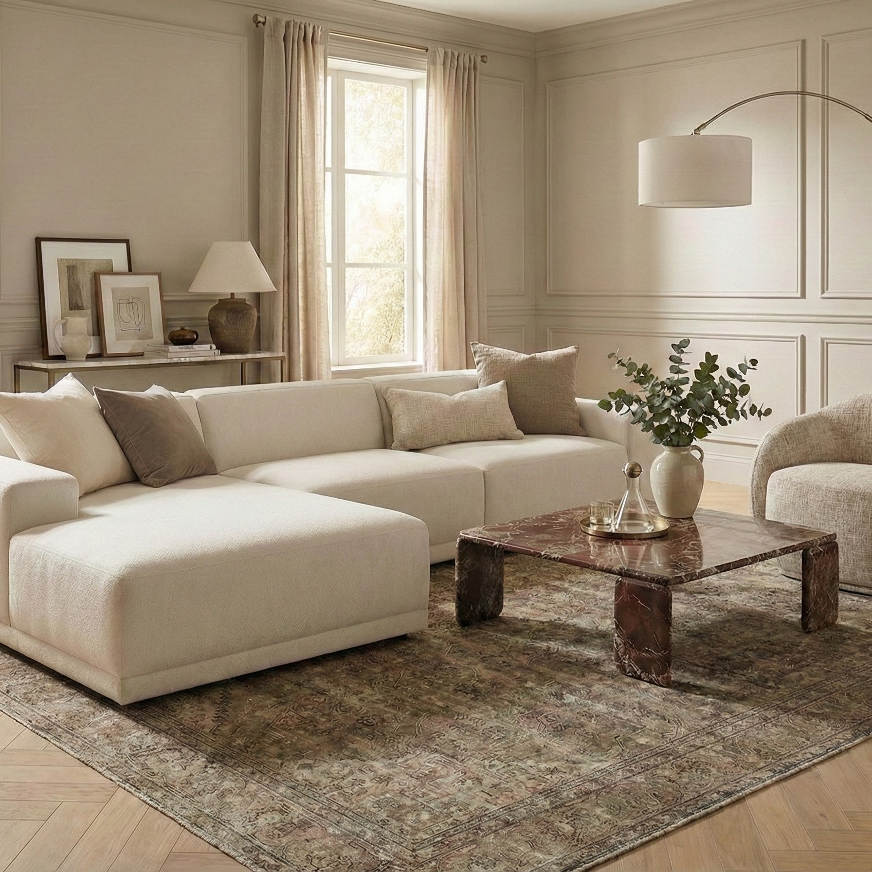 Solis beige linen modular sectional sofa styled in a warm neutral living room with a marble coffee table and vintage rug.