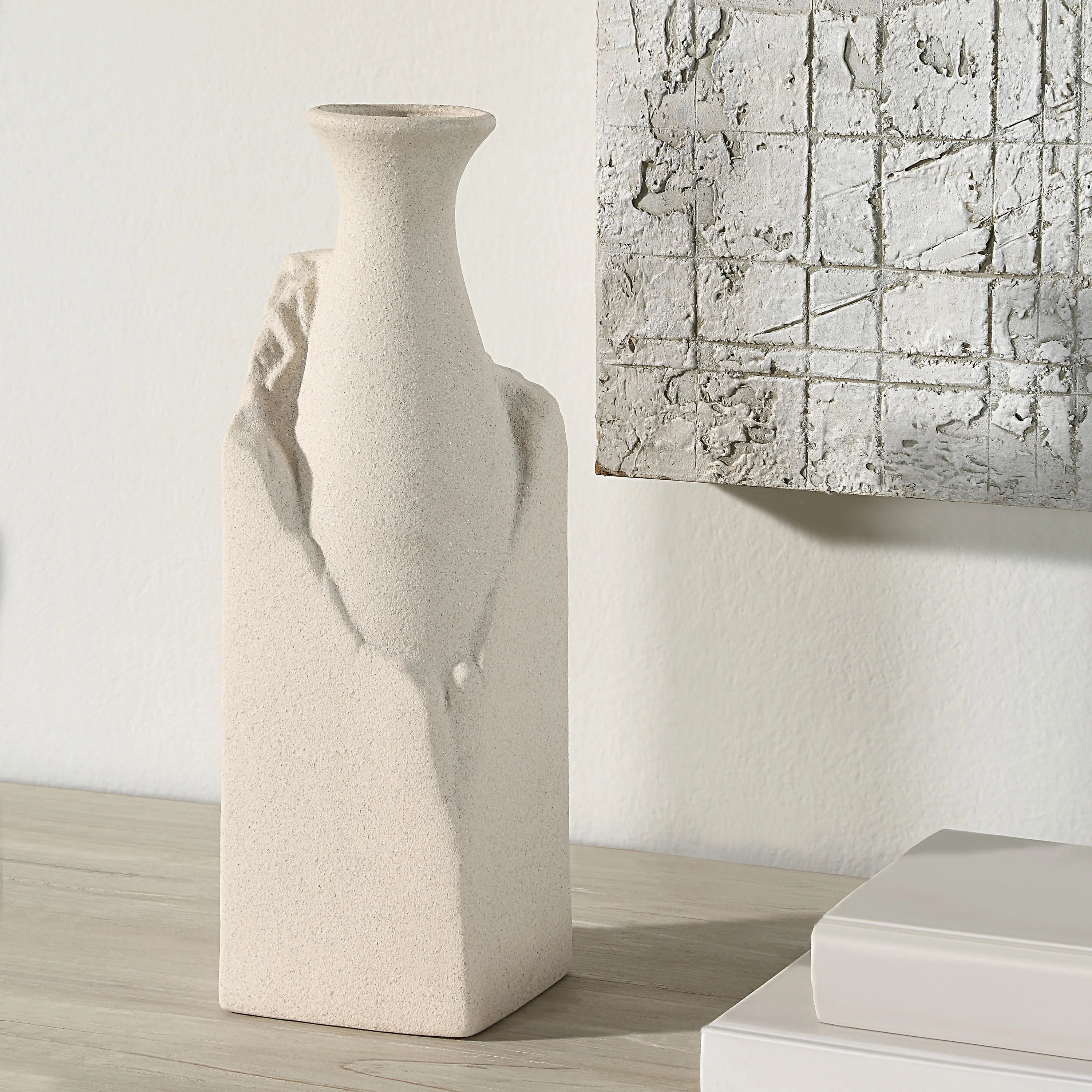 Terra Ridge Ceramic Vase displayed on wooden surface beside abstract wall art