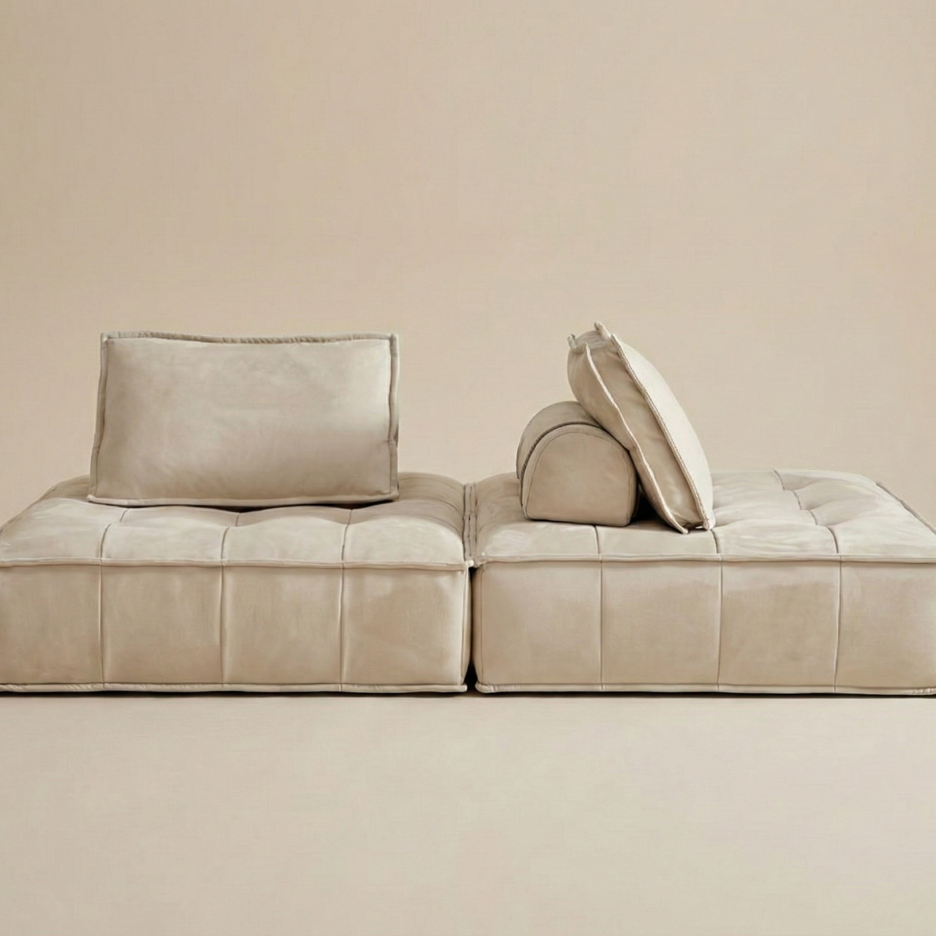 Beige sofa with cushions on a beige background
