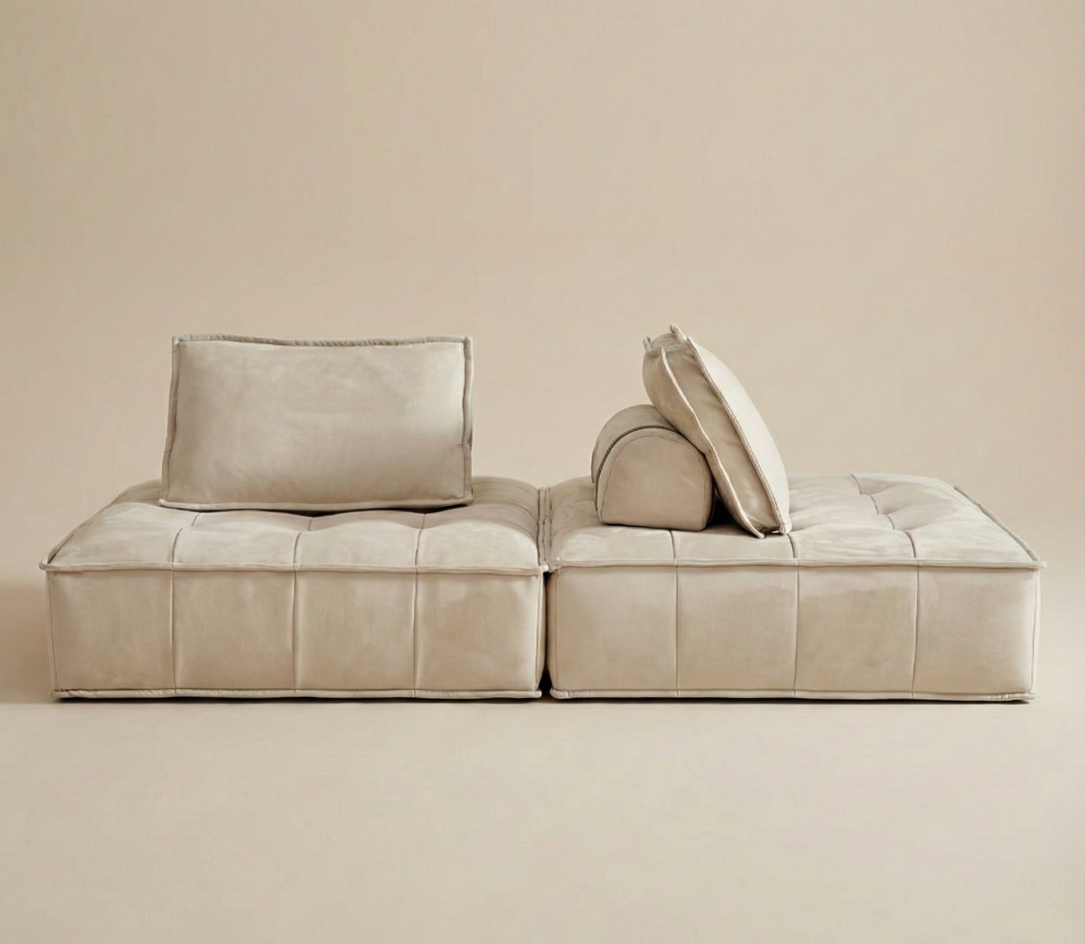 Beige sofa with cushions on a beige background